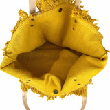 a yellow bag with fringes hanging from a hook