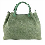 a green handbag is shown on a white background