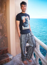 a man standing on a balcony next to the ocean