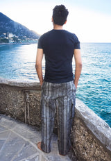 a man standing on the edge of a pier looking at the water