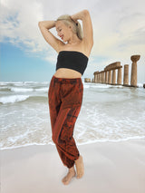 Handmade red hippie pants on beach with columns