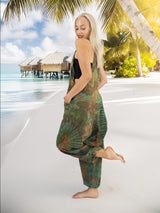a woman standing on a beach in front of a hut