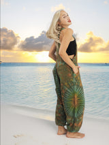 a woman standing on a beach next to the ocean