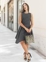 Model leaning with python embossed handbag