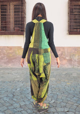 a woman standing on a skateboard on a cobblestone street