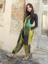 a woman standing next to a stone building