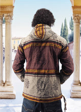 a man standing in front of pillars wearing a jacket