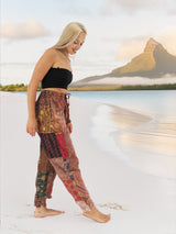 a woman standing on a beach next to a body of water