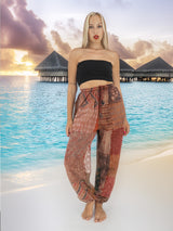 a woman standing on a beach next to a body of water