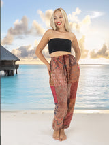 a woman standing on a beach with her hands on her hips