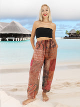 a woman standing on a beach in a black top