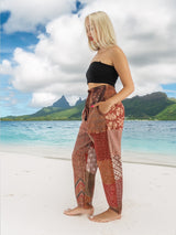 a woman standing on a beach next to the ocean