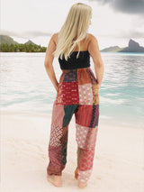 a woman standing on a beach with her back to the camera