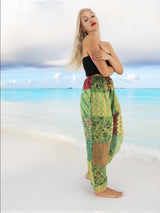 a woman standing on a beach with her arms crossed