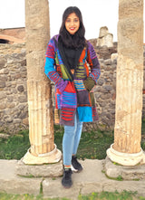 a woman standing in front of two stone pillars