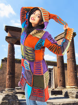 a woman in a colorful dress standing in front of columns