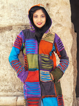 a woman standing in front of a stone wall