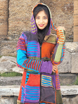 a woman in a colorful coat posing for a picture
