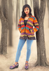 a woman standing next to a tree in a forest