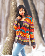 a woman standing next to a tree in the snow