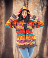 a woman in a colorful jacket is posing for a picture