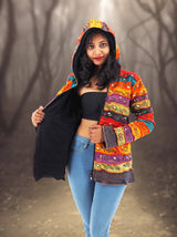 a woman in a colorful jacket posing for a picture