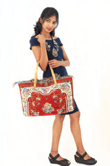 a woman is holding a red and white bag