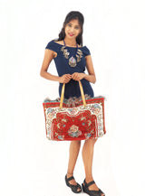 a woman is holding a red and white bag