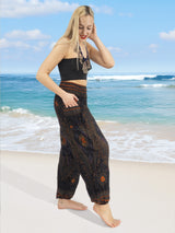 a woman standing on a beach next to the ocean