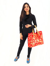a woman in black holding a red bag