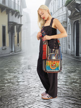 Colorful handmade cotton hemp hippie handbag purse with a stonewash finish, worn by a model walking through a historic European-style street.