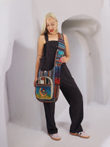 Bohemian-style handmade cross body handbag crafted from cotton hemp, displayed by a model against a white architectural backdrop. Spacious and fair trade-made.
