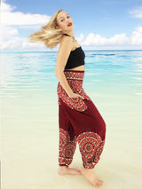 a woman standing on a beach with her hair blowing in the wind
