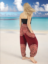 a woman standing on a beach with her back to the camera