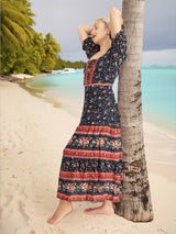 a woman leaning against a palm tree on a beach