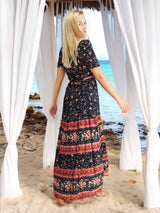 a woman in a long dress standing under a gazebo