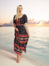 a woman standing on a beach next to the ocean