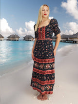 a woman standing on a beach next to the ocean