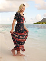 a woman standing on a beach next to the ocean