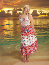 a woman in a red and white dress standing on a beach
