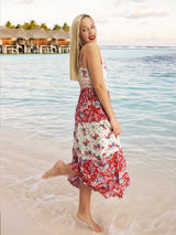 a woman standing on a beach next to the ocean