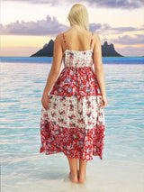 a woman in a red and white dress standing in the water