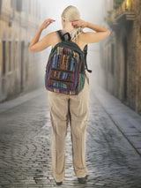 Large handmade cotton hemp backpack with multiple pockets and adjustable straps, displayed by a model adjusting the fit. A stylish and functional travel bag.
