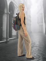 Handmade cotton hemp backpack with a boho-chic aesthetic, worn by a model in a historic cityscape. Spacious and stylish for everyday use.