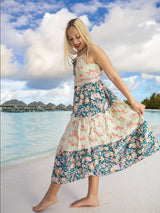 a woman standing on a beach next to the ocean