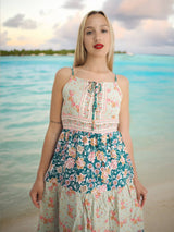 a woman standing on a beach next to the ocean