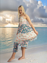 a woman standing on a beach next to the ocean