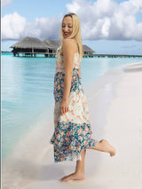a woman standing on a beach next to the ocean