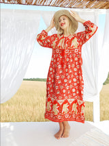 a woman in a red dress and a straw hat