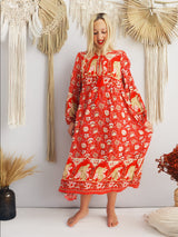 a woman in a red dress standing in front of a wall